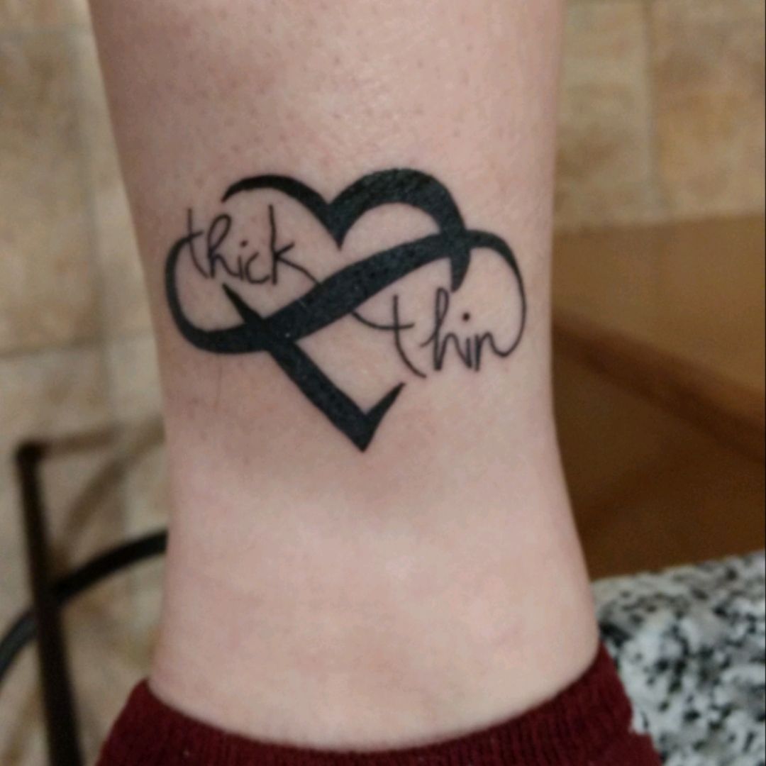 Side tattoo saying Through thick and thin on Maria