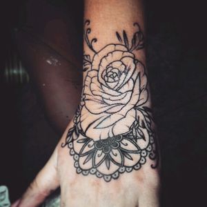 There is a mandala anda rose tattoo.