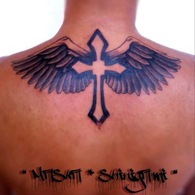 tribal cross with wings on arm