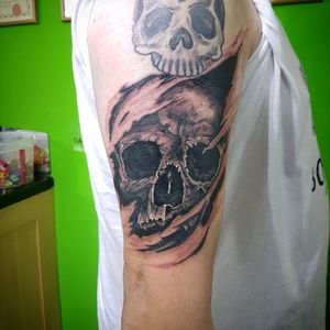 Realitic ripped scin skull by sam the witch.