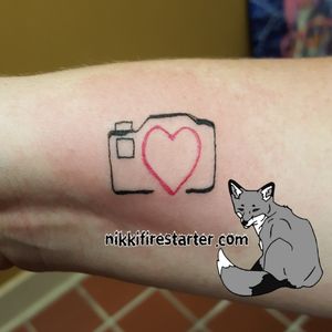Lil camera with heart from our Friday the 13th special on the wrist!http://nikkifirestarter.com#camera #tattoos #cameratattoos #smalltattoos #wristtattoos #photography #photographytattoos #minimalisttattoos #linework 