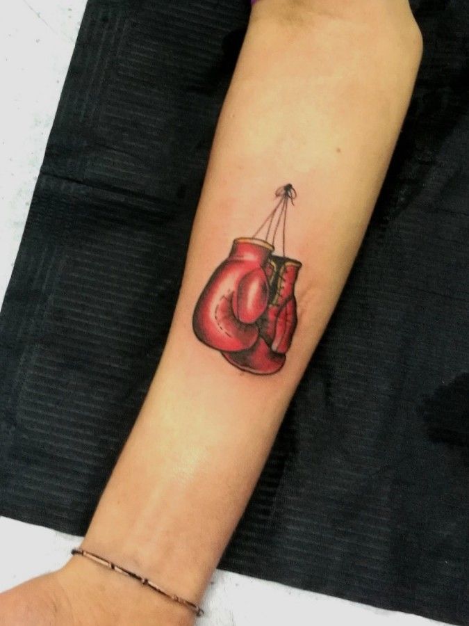 Fine line boxing gloves tattoo located on the inner