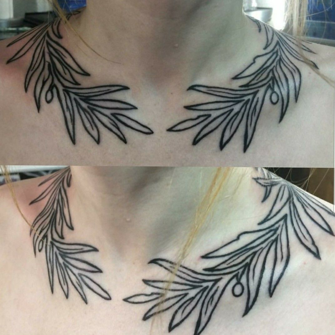 Laurel wreath tattoo on the right inner forearm