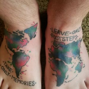 Watercolor tattoo of the continents done by Tim Mueller art in L.A.Quote says "Take only memories leave only footsteps"