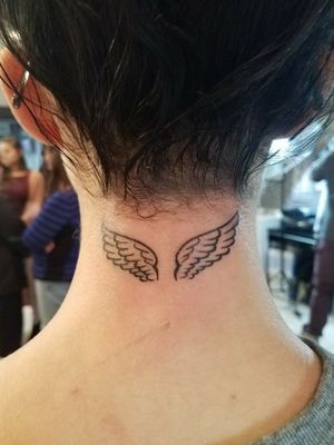 small wings behind the neck tattoo