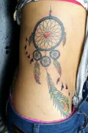 Dreamcatcher. Flying birds. Colored feathers
