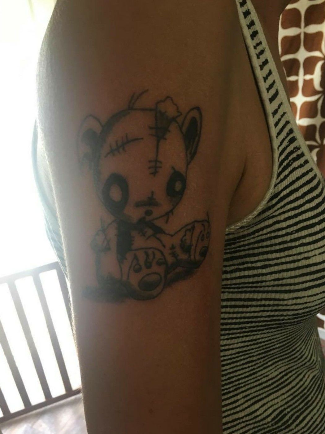 broken teddy bear tattoo