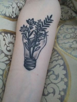 Broken lightbulb with wild flowers by Dema Denisevich at Ink Slingers in Springfield, Mo