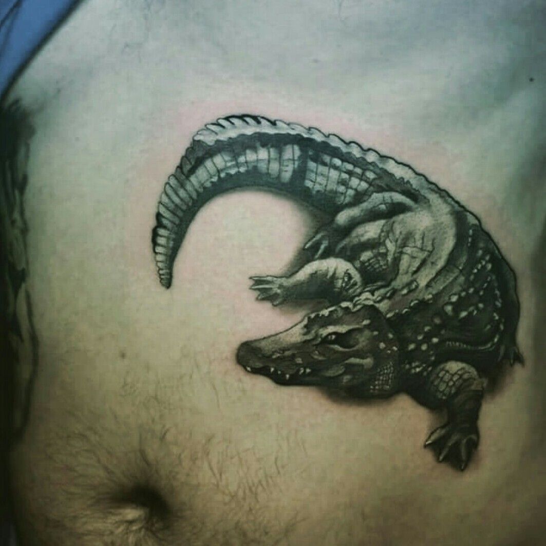Microrealistic crocodile tattoo on the forearm