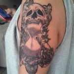 Sandclock skull tattoo up arm 