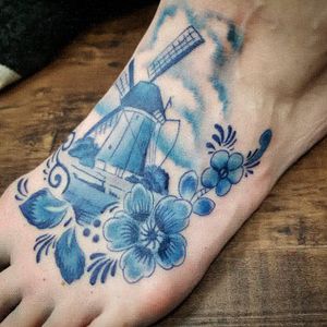 Delft Blue themed tattoo. Done in a greyscale style, with blue concentrate. 