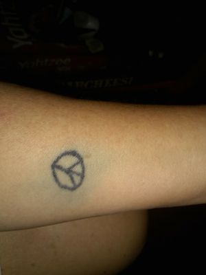 First tattoo.Peace sign.Hate the ink bleed.  Suggestions for cover-up!!!