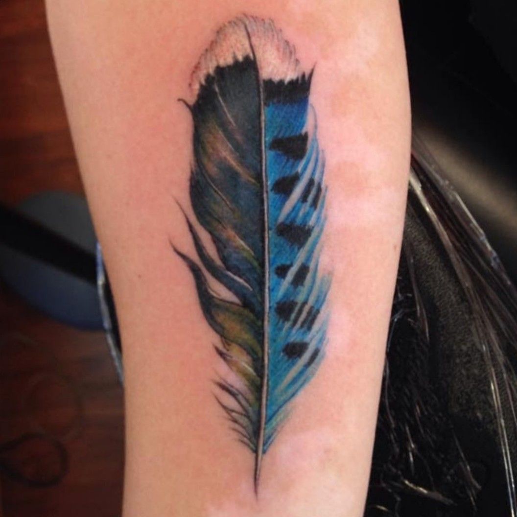 Crazy Ink Tattoo  Body Piercing Raipur  BLACK AND BLUE FEATHER TATTOO The  small feather tattoo is among the popular design in tattoos due its  aesthetic beauty and ease to adapt