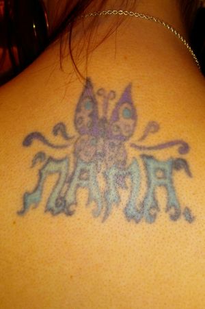 This was my very first tattoo that I got when I was 16 years old. I got it for my grandma (who adopted me so she was also my mom) after she passed away. Its (obvously) a butterfly and underneath it says "Nana" which was what we called her. I chose the colors purple and blue because they were two of her favorite colors; and I chose a butterfly because she loved them a lot! Its on my upper back/lower neck. 
