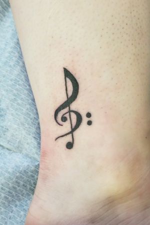 First tattoo right on the ankle. Treble cleff with bass clef incorporated into it