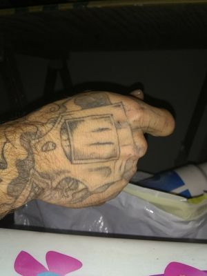 Revolver hand tattoo