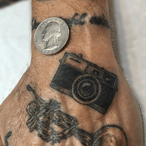 Tiny Minolta hand tattoo by joemagstattoo! He works Thursday through Sunday so hit him up for a great tattoo! #originalbrooklynink #brooklynink #minolta #camera #cameratattoo #handtattoo #microtattoo #blackandgraytattoo