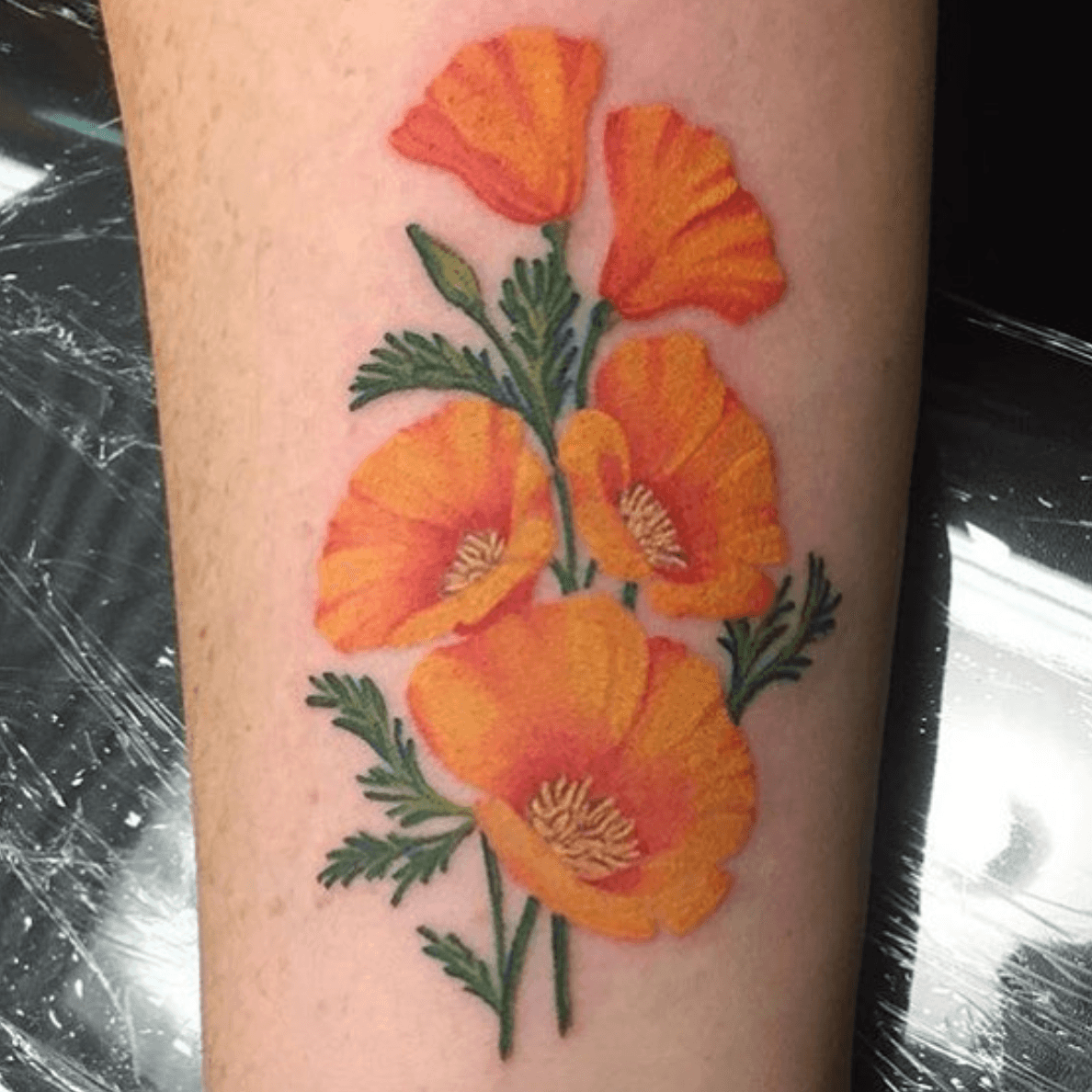 Bright Orange California Poppy Flower leg tattoo
