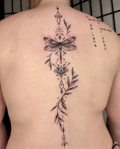 Alice Hope Tattoo's intricate design features a dragonfly, lotus, and vine in detailed blackwork and dotwork style.