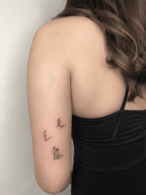 Fine line illustrative tattoo featuring tiny people representing family, in black and gray by Winnie Shwe.