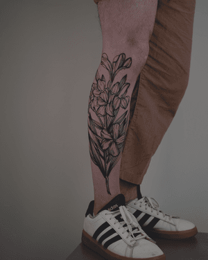 Detailed floral design in blackwork style, etched with intricate botanical elements by artist Alona Hamova.