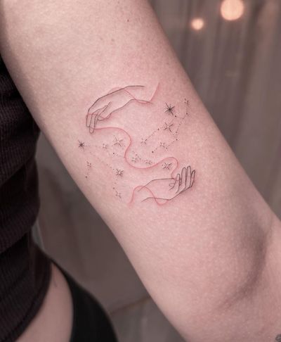 Fine line, illustrative tattoo by Ally.ink featuring a delicate and minimal constellation connected with a red thread among the stars.