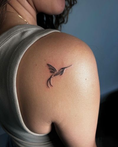 Illustrative black and gray tattoo of a hummingbird by Ruby Rowland. A delicate and intricate design capturing the beauty of this swift and tiny bird.