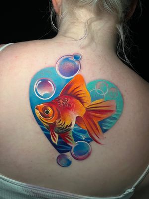 Unique and vibrant illustrative tattoo by Cloto.tattoos featuring a heart and goldfish design in beautiful watercolor style.