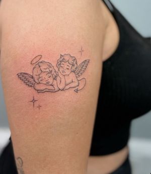 Unique fine line and illustrative tattoo by Sally featuring a blend of devil, angel, and cherub motifs.