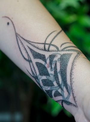 Elegant blackwork by Mona Noir Tattoo, featuring intricate dotwork and ornamental designs in a flowing organic motif.