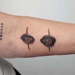 A micro realistic tattoo of Alice Coopers eyes reminiscent of a dark aesthetic. The technique focuses on the contrast of light and shadow, creating a dramatic effect.