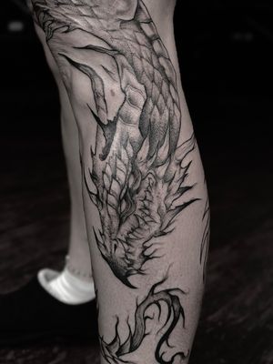 Closeup dark dragon leg tattoo 