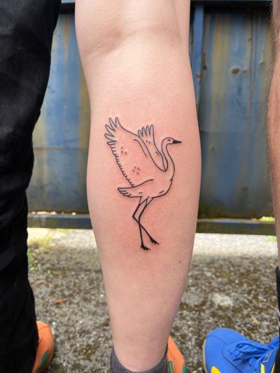 Bold blackwork tattoo of a bird, crane, or heron by artist Dave Norman. Ignorant style with intricate linework.