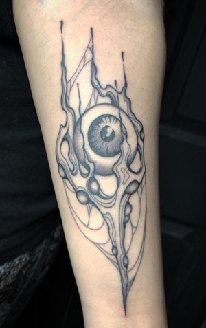 An illustrative tattoo by Amandine Canata featuring an abstract and organic design of an eye in black and gray tones.
