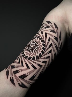 Get mesmerized by this ornamental dotwork tattoo featuring a stunning spiral pattern, expertly executed by artist Hamid.