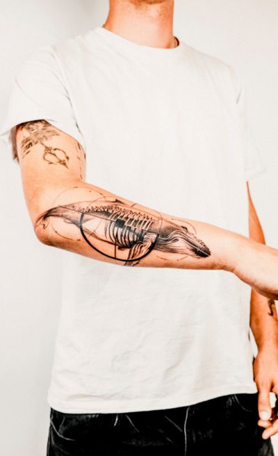 Gabriele Edu's blackwork tattoo combines a whale motif with geometric elements in a striking and abstract design.