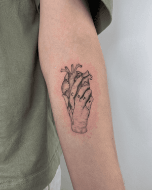 A soft yet intricate design of a hand holding a bleeding heart! 