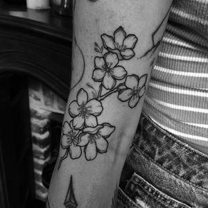 Illustrative tattoo by Barbara Nobody featuring a tree, flower, and branch motif. Perfect for nature lovers.