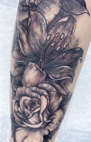 Beautifully detailed flower tattoo by Alfonso Barberio, showcasing the artistry of black & gray ink techniques.