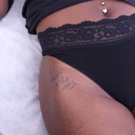 Fine line floral hip tattoo
