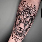 This stunning ornamental tattoo features a lioness in intricate dotwork style, expertly crafted by the talented artist Hamid.