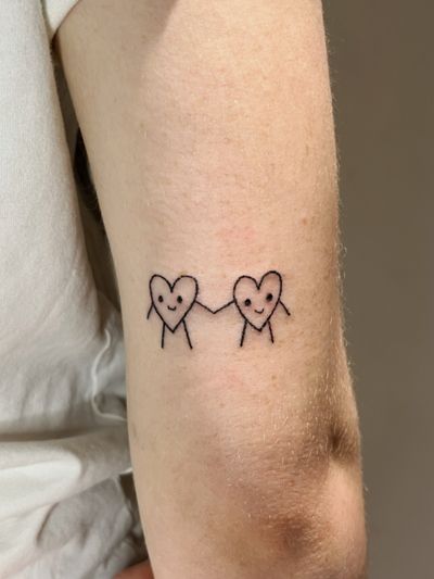 Fine line hand-poked heart-shaped doodle design by Laura, combining whimsical elements for a playful look.