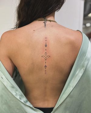 Adorn your body with this delicate ornamental tattoo featuring a stunning pattern, expertly executed by tattoo artist Ellie Shearer.