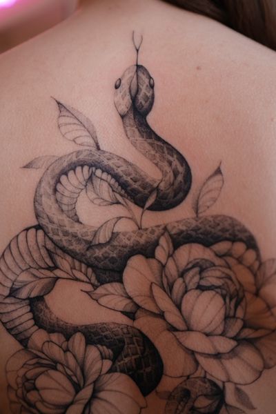 Get a captivating black and gray snake tattoo done with exquisite fine line work by talented artist Maria.