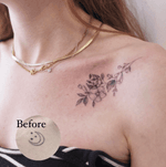A cover-up tattoo on the collarbone of a delicate fineline floral blossom flower design