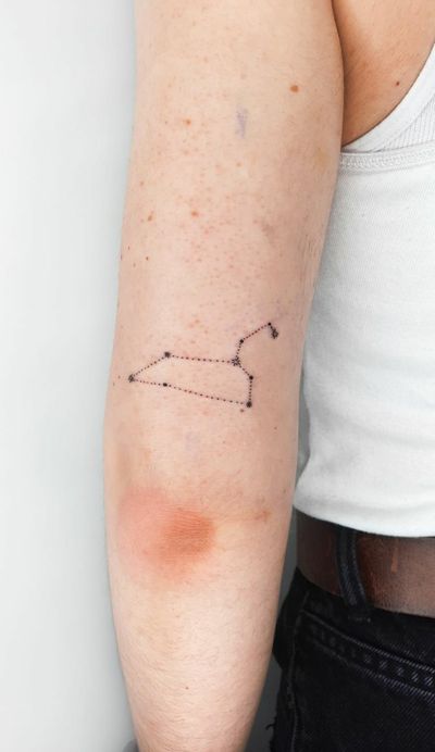 Get inked with a stunning fine line constellation tattoo by Liberty C Tattoo, inspired by the beauty of the night sky. Schedule your appointment now!