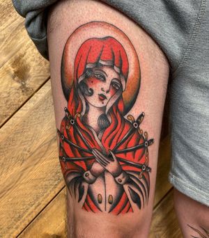 Experience the merging of illustrative and traditional styles with this captivating tattoo featuring a mysterious gypsy lady and a powerful dagger, skillfully crafted by artist Megan Foster.
