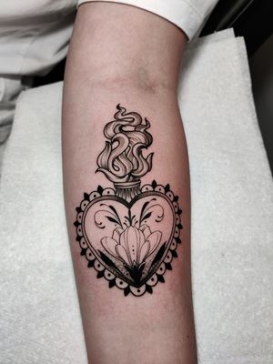 Beautiful blackwork fine line tattoo by Mary Shalla featuring a sacred heart design with art nouveau elements and intricate floral motifs.