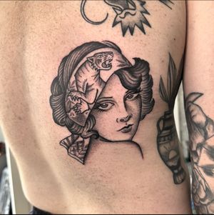 Experience the timeless elegance of a vintage lady tattoo in black and gray, neo Traditional, or traditional style by talented artist Sam Waiting.