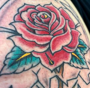 Elegant traditional rose tattoo design by skilled artist Marc Caplen. Perfect for a timeless and classic look.